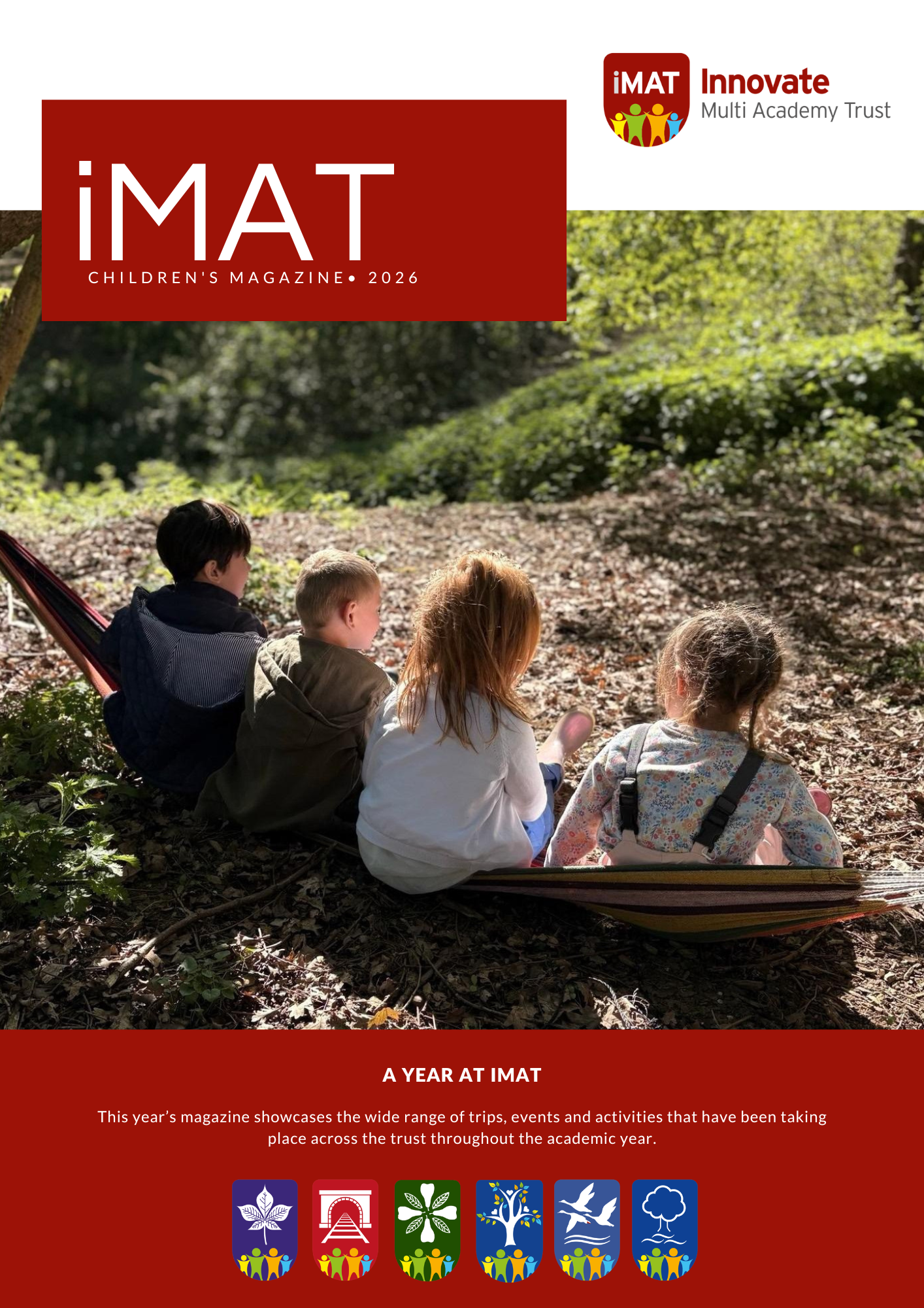 Cover for the 25/26 iMAT magazine, showing four nursery pupils sitting in the sun in a woodland area
